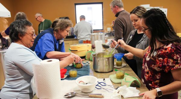 group of people in a kitchen space doing steps to food preservation 