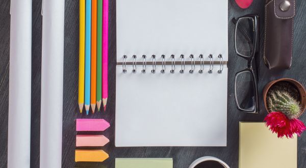 various office supplies. colored pencils, glasses , post it pads, reading glasses, cacti 